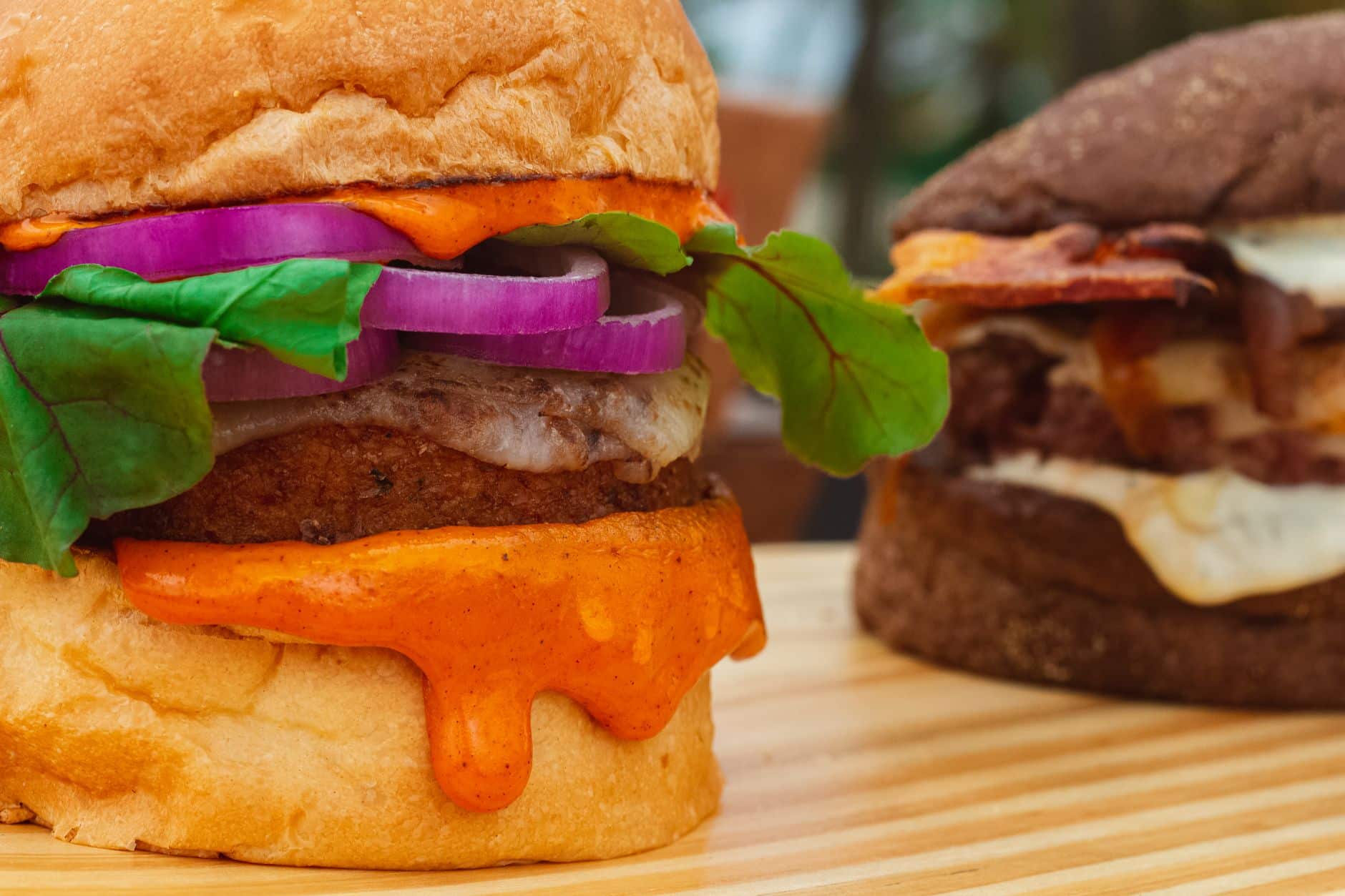 Mouth-watering close-up of gourmet burgers with fresh toppings, perfect for food enthusiasts.