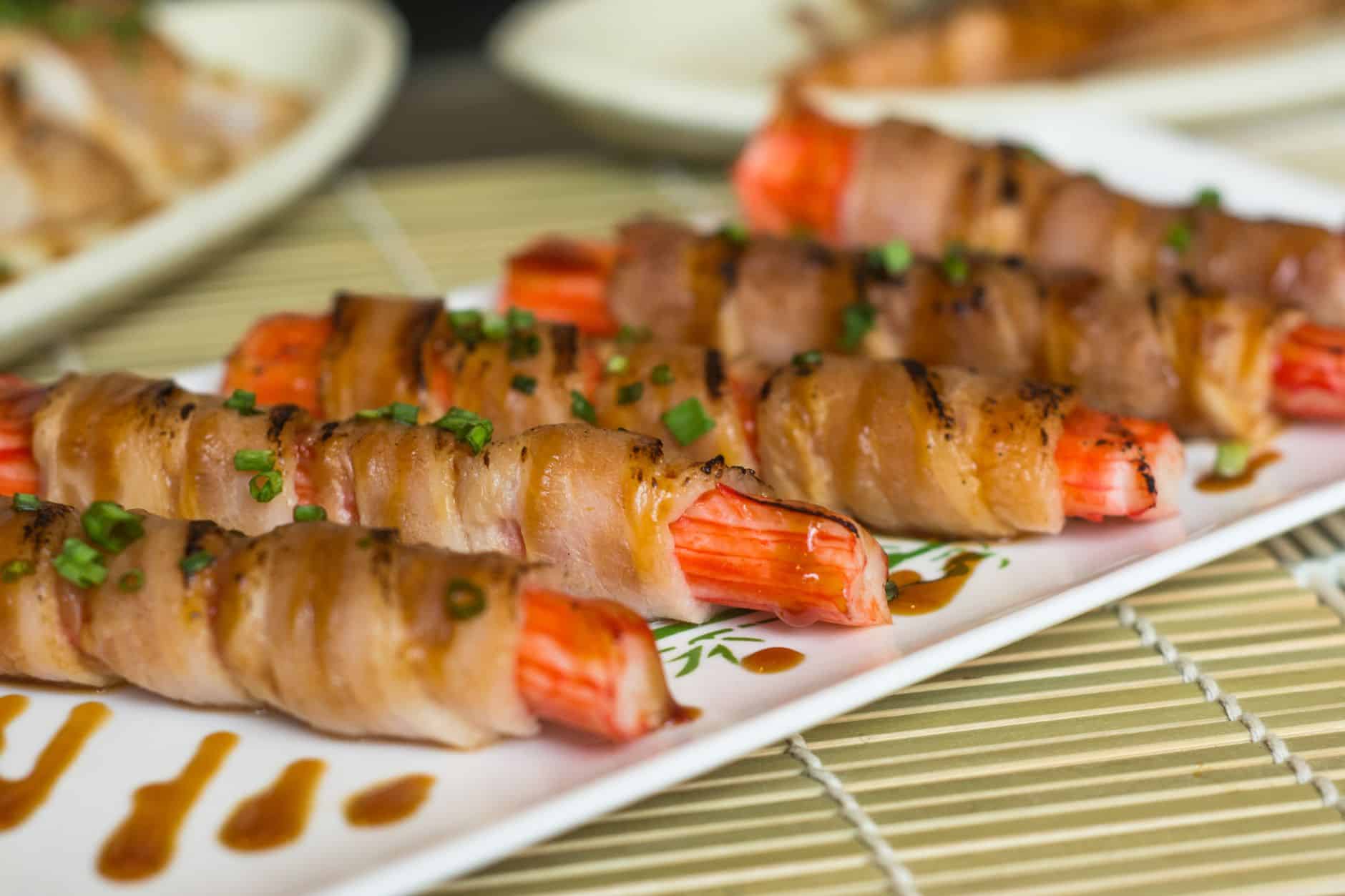 Delicious bacon-wrapped shrimp appetizer with green onion garnish, perfect for gourmet dining.