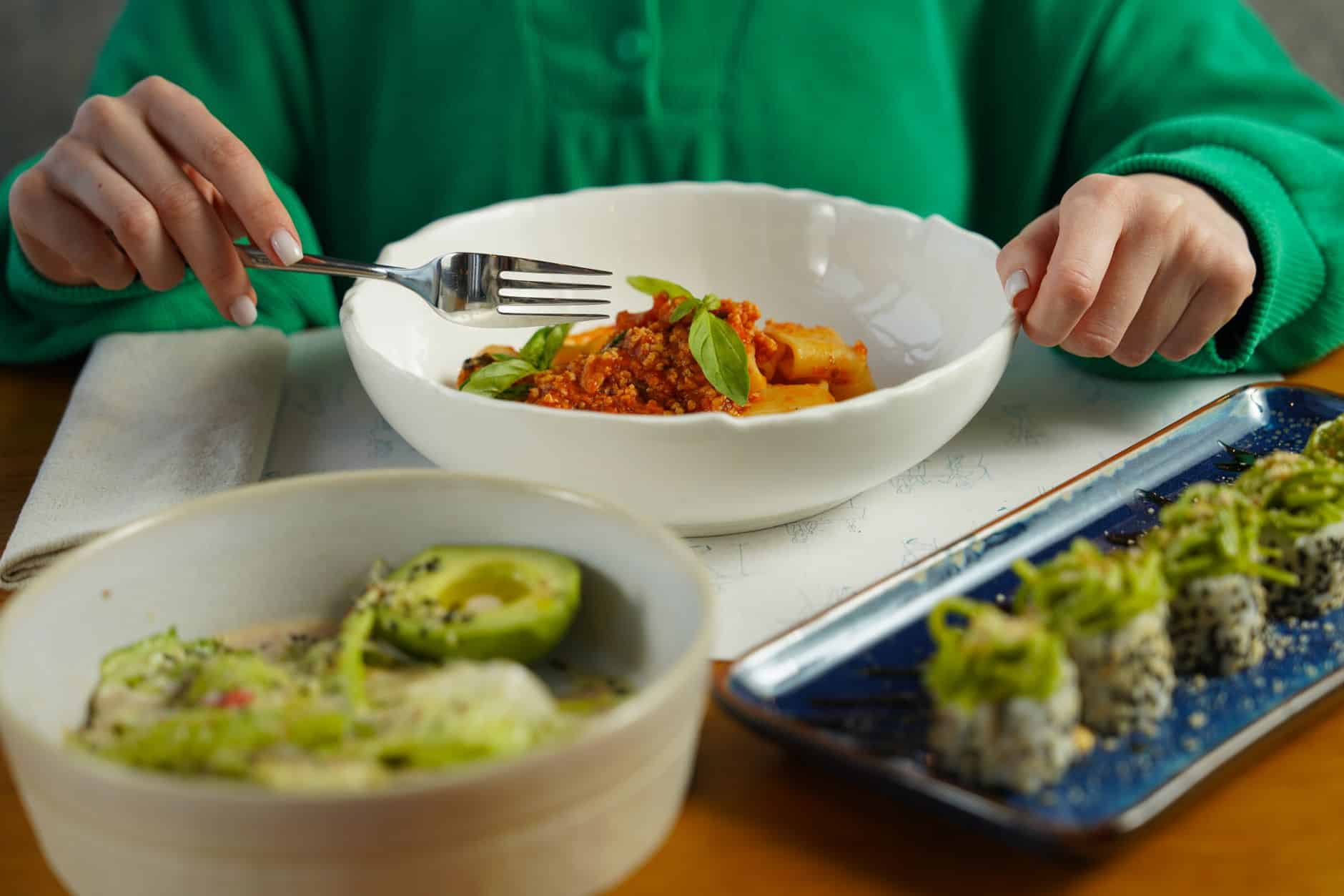 A delicious fusion meal featuring Italian pasta and sushi, showcasing diverse culinary delights.