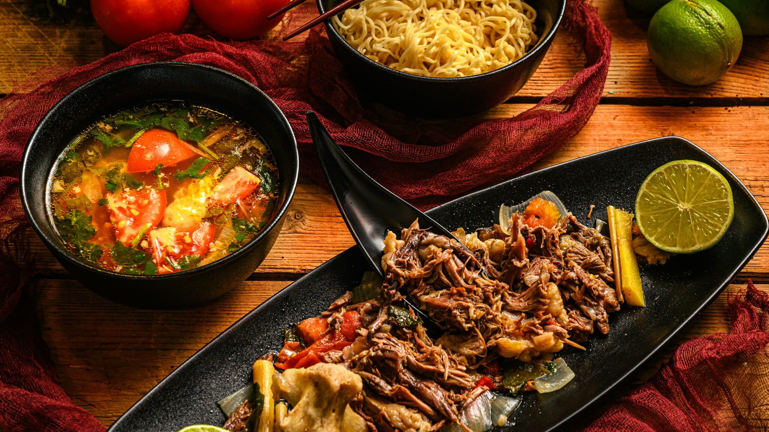 a table topped with bowls of food and bowls of soup